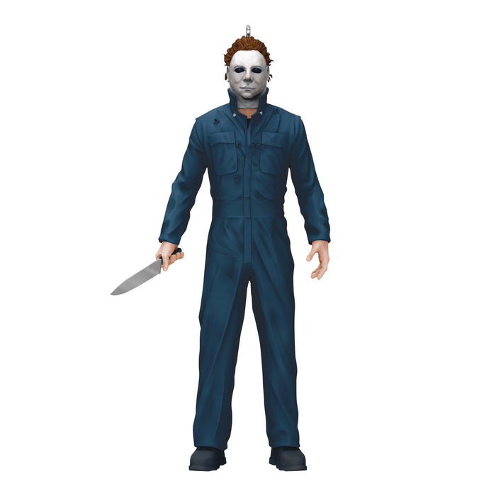 Action figure in blue coveralls with a white mask holding a knife on a white background