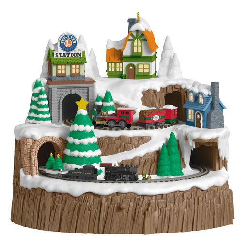 Toy train set with buildings and trees on a snowy landscape