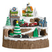 Toy train set with buildings and trees on a snowy landscape