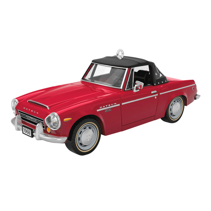 Red model car with black top on a white background