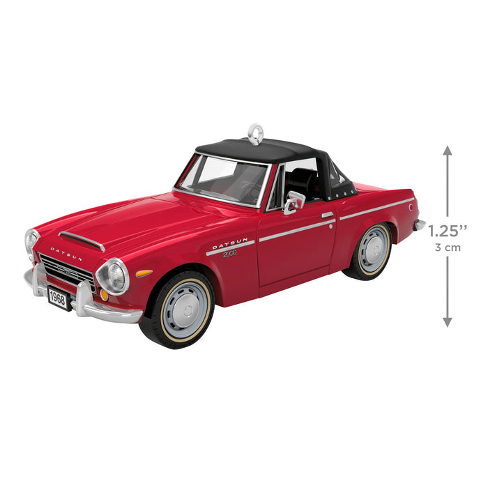 Red model car with black top on a white background