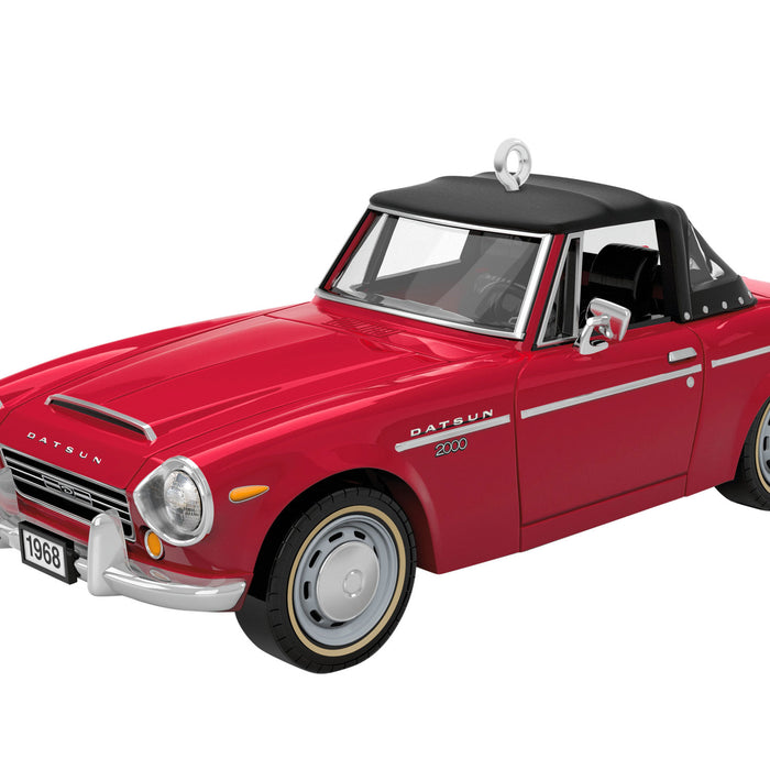 Model of a red Datsun car on a white background