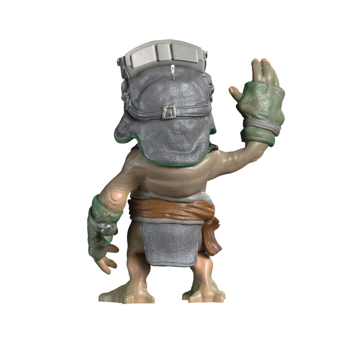 Action figure with a gray helmet and green gloves on a white background