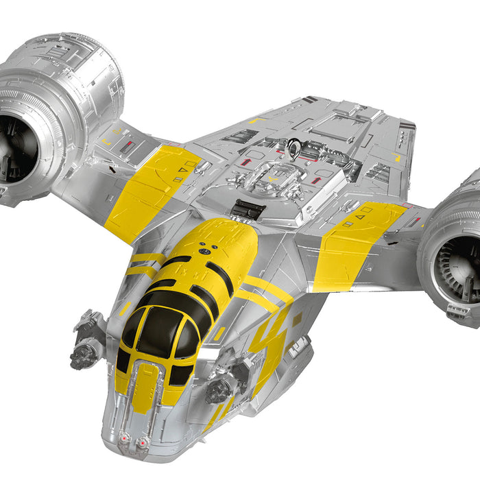 Model of a spaceship with yellow and gray design on a white background