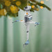 Star Wars X-wing fighter model ornament hanging on a Christmas tree.