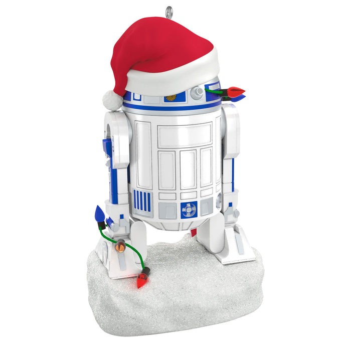 Decorative ornament of a robot with a Santa hat on a white background