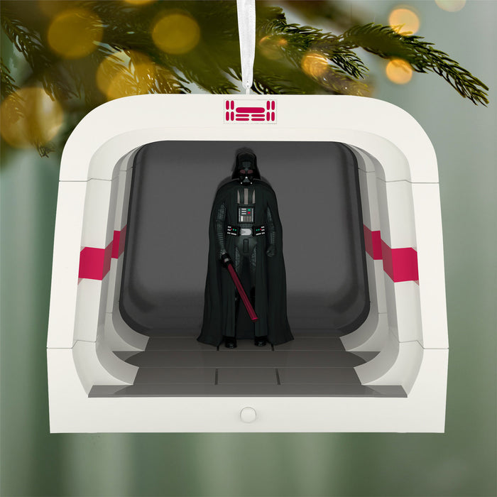 Decorative ornament with Darth Vader figure in a spaceship, hanging from a tree.
