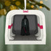 Decorative ornament with Darth Vader figure in a spaceship, hanging from a tree.