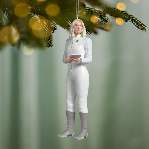 Decorative ornament of a person in equestrian attire hanging from a tree branch.