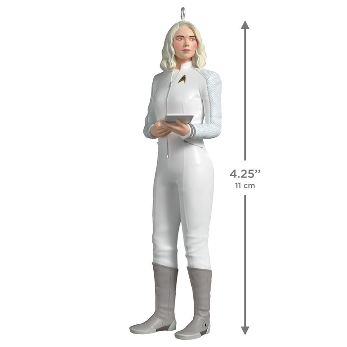 Character figurine in a white outfit with measurement details on a white background