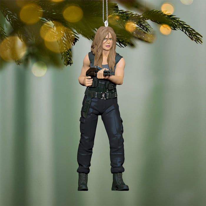 Action figure ornament of a character in tactical gear hanging on a Christmas tree.