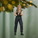 Action figure ornament of a character in tactical gear hanging on a Christmas tree.
