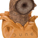 Close-up of a character head with a textured face and 'Dune' branding on a white background