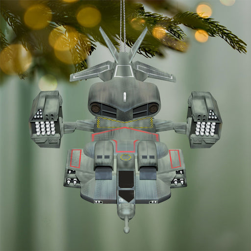 Decorative robot ornament hanging on a Christmas tree with a festive background.