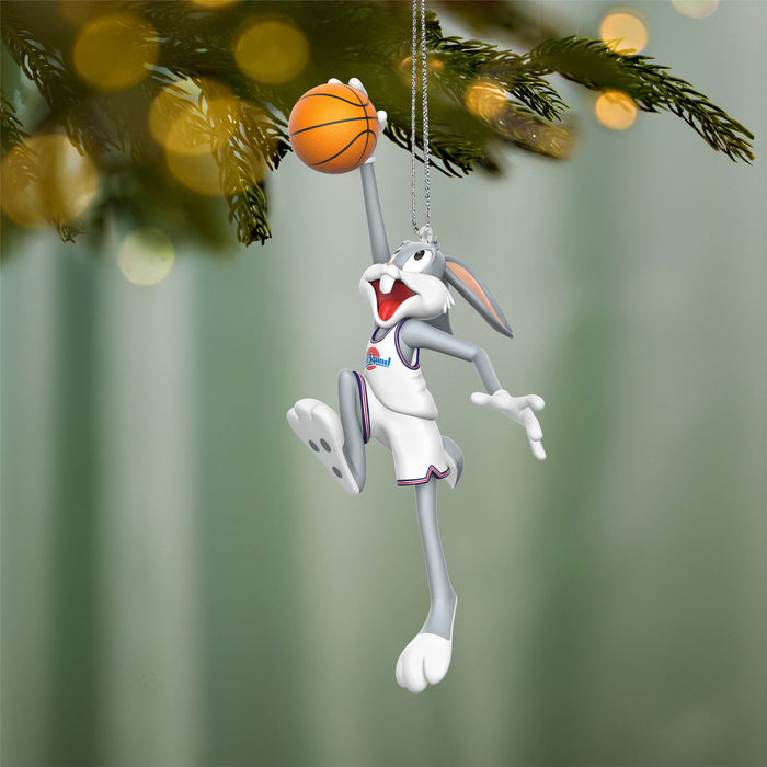 Decorative ornament of a cartoon character holding a basketball, hanging from a Christmas tree.