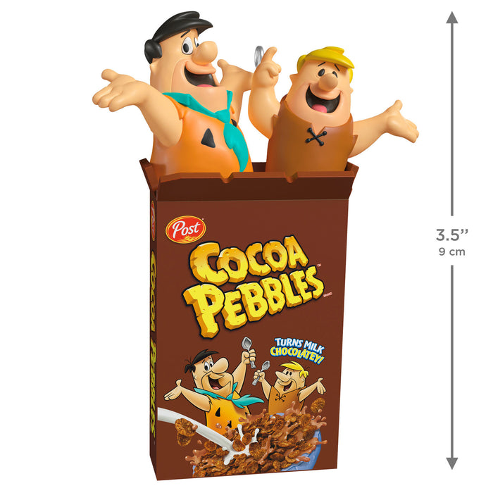 Two cartoon characters in a Cocoa Pebbles cereal box with dimensions indicated.