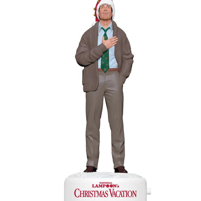 Statue of a character from 'National Lampoon's Christmas Vacation' wearing a sweater and tie on a white background.
