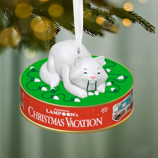 Christmas ornament with a white cat design on a green and red base, featuring 'National Lampoon's Christmas Vacation'.