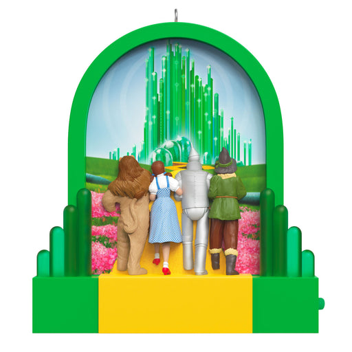 Ornament featuring characters from 'The Wizard of Oz' with a green arch and yellow base.