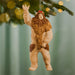 Sasquatch ornament hanging on a Christmas tree with a blurred green background