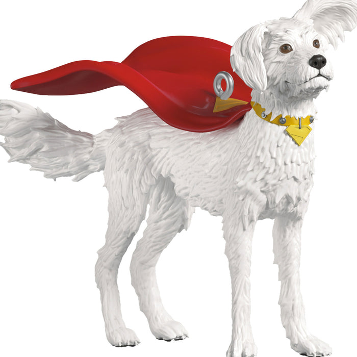 White dog wearing a red superhero cape and yellow mask on a white background