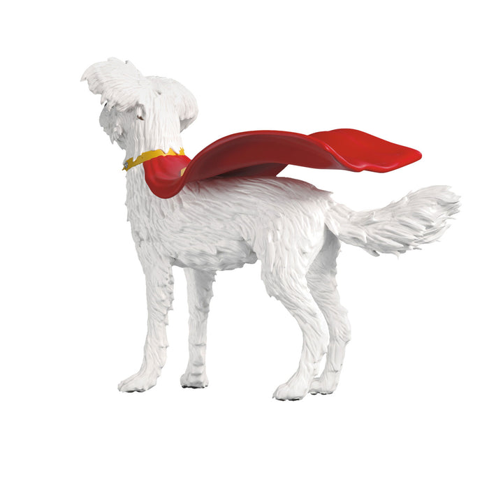White dog figurine with a red cape on a white background
