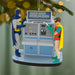 Christmas ornament featuring Batman and Robin with the Batcomputer on a green background.