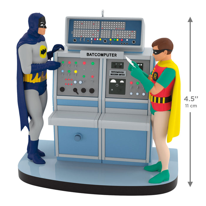 Two superhero figures standing next to a Batcomputer with a measurement indicator.
