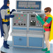 Two superhero figures standing next to a Batcomputer with colorful buttons and displays.