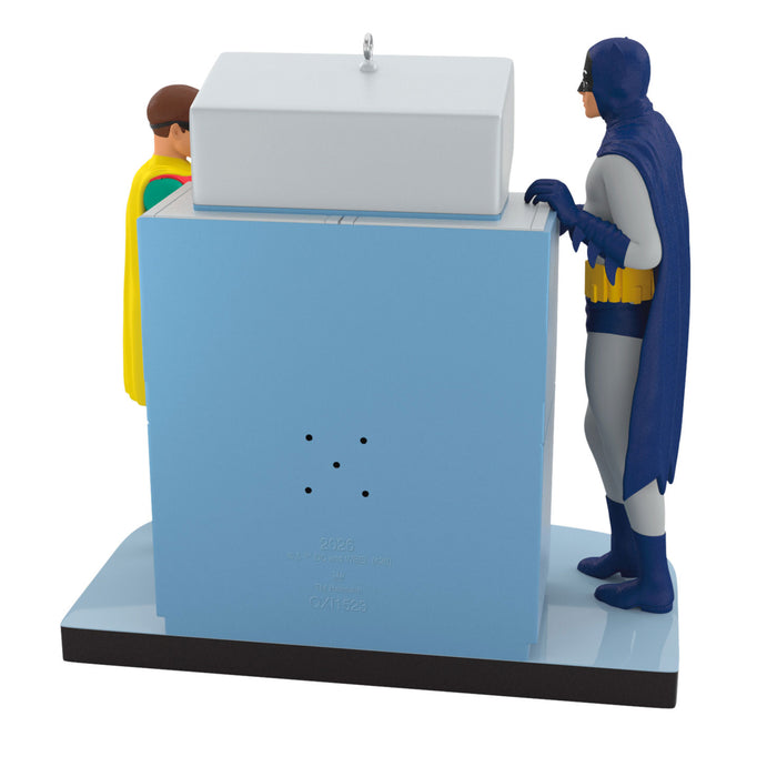 Two superhero figures interacting with a blue machine on a white background