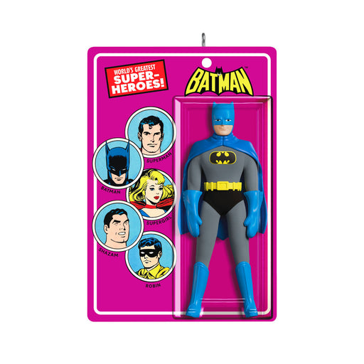 Vintage-style Batman action figure in packaging with superhero illustrations on a pink background