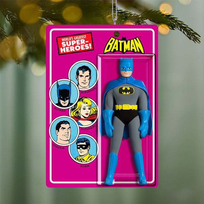 Batman action figure in packaging with superhero illustrations on a pink background