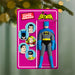Batman action figure in packaging with superhero illustrations on a pink background