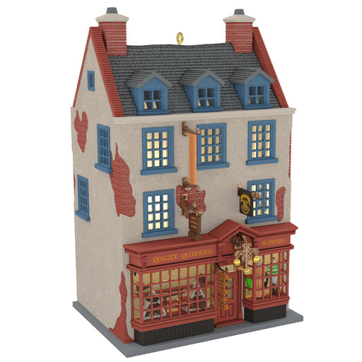 Model of a two-story building with a red roof and blue windows on a white background