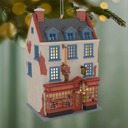 Decorative house ornament with lit windows on a green background