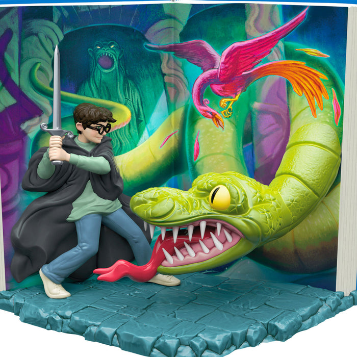 Figurine of a character with a sword facing a large dragon in front of a colorful background