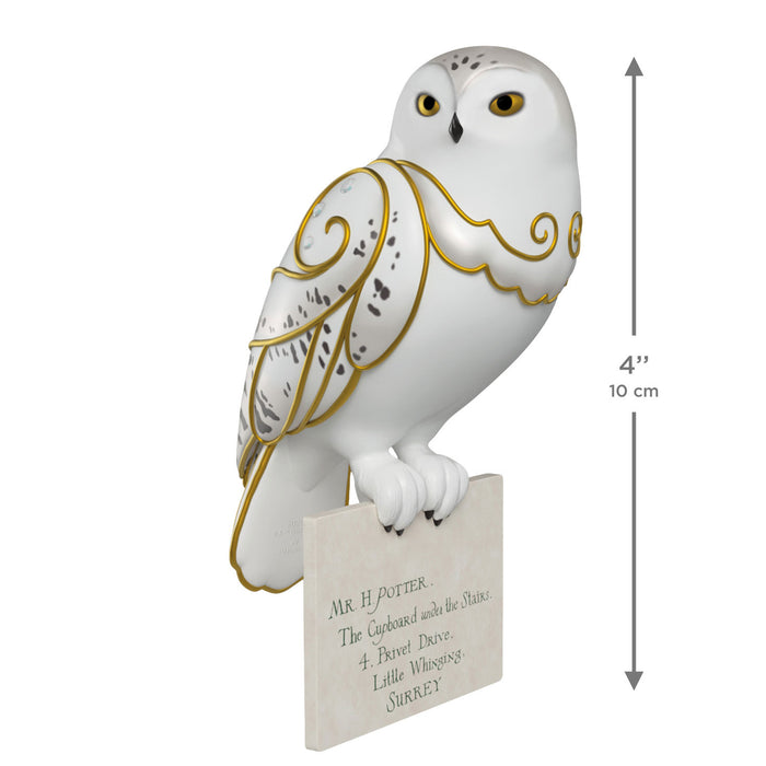 Decorative owl figurine with gold accents on a white background