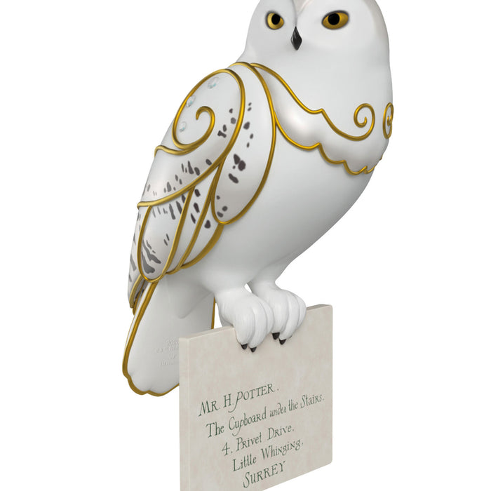 Decorative owl figurine with gold detailing on a white background