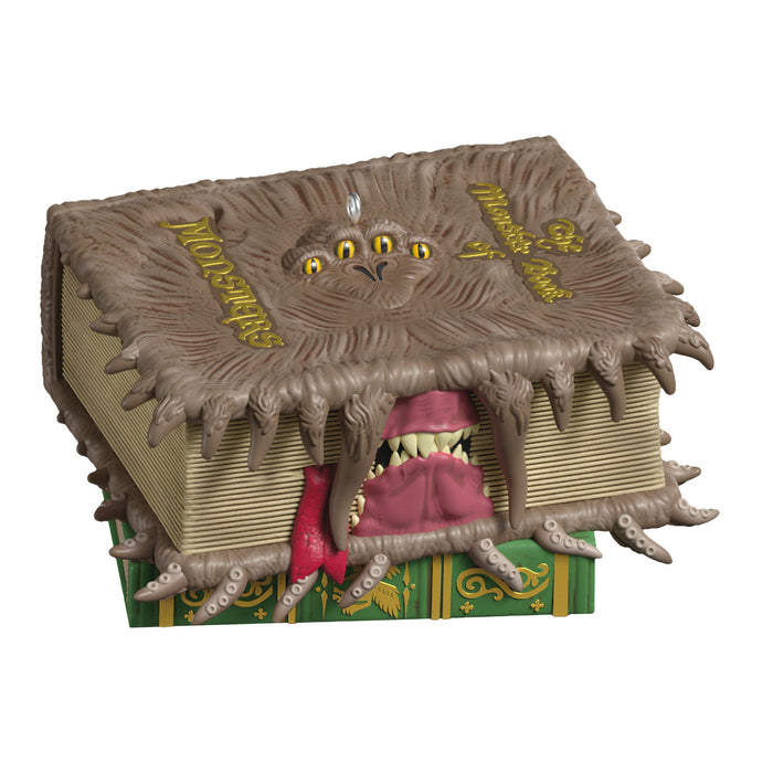 Monster book with a creature emerging from it on a white background