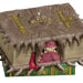 Toy figure of a creature emerging from a book with 'Monsters University' branding.
