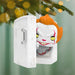 Decorative Christmas ornament with a character in a white box against a festive background