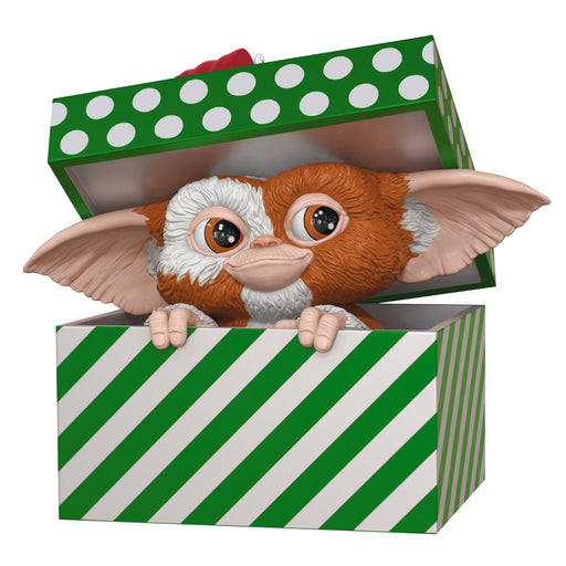 Toy figure of a character with large ears peeking out of a green and white striped box.