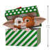 Gizmo toy figure peeking out from a green and white striped box with a polka dot lid.