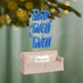 Decorative ornament with 'Pivot Pivot Pivot' text and 'Friends' couch, hanging against a festive background.