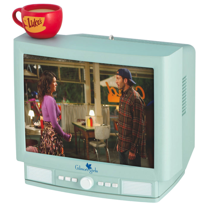 Vintage-style television set displaying 'Gilmore Girls' with a red mug on top
