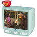 Vintage-style television set displaying 'Gilmore Girls' with a red mug on top