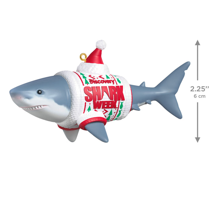 Shark-shaped ornament with a Santa hat and 'Shark Week' text on a white background