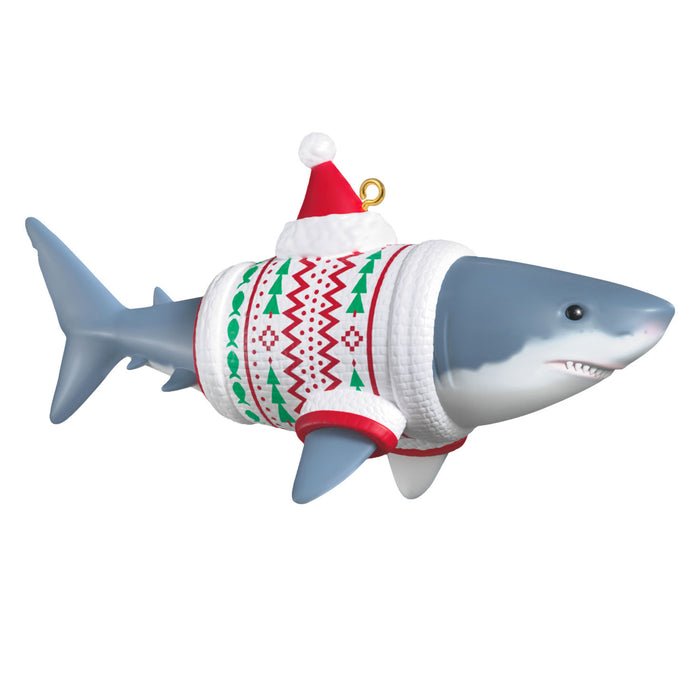 Shark ornament wearing a sweater and Santa hat on a white background