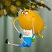 Christmas ornament featuring a yellow creature and a blue character hanging from a tree branch.