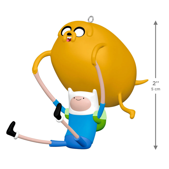 Small figurine of a cartoon character being lifted by another character with dimensions indicated.